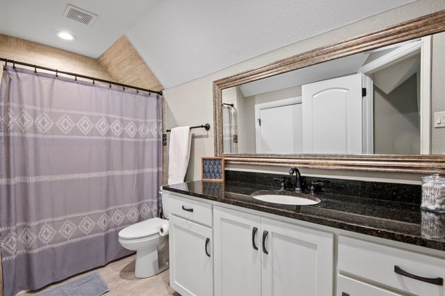 Bathroom featuring vanity and a shower with curtain | Image 26