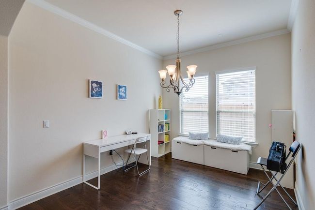 Dining space featuring baseboards, ornamental molding, dark wood finished floors, and a notable chandelier | Image 7