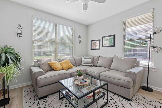 Living room featuring a ceiling fan and light wood-style flooring | Image 4