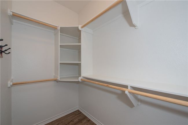 Spacious closet featuring wood finished floors | Image 11
