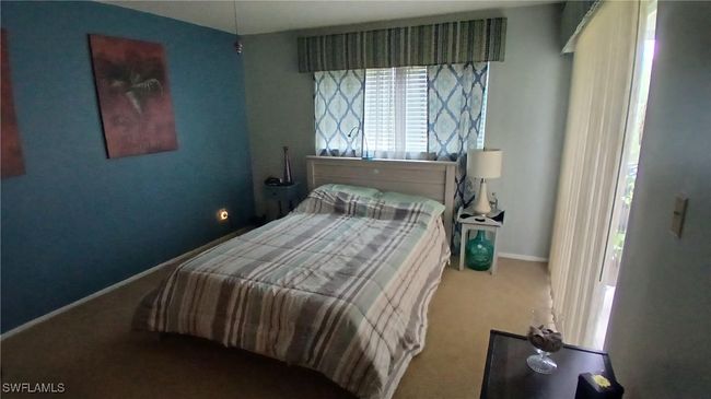 View of carpeted master bedroom with walk in closet | Image 14