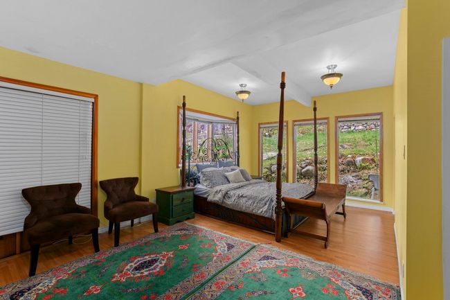 Bedroom with beam ceiling and wood finished floors | Image 13