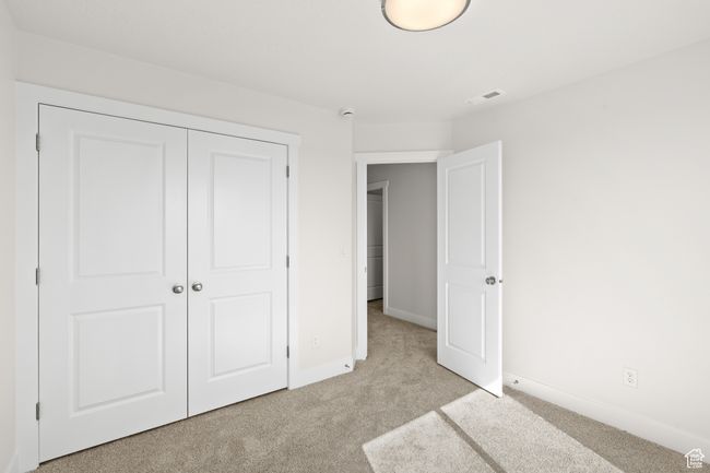 Unfurnished bedroom featuring light carpet and a closet | Image 28