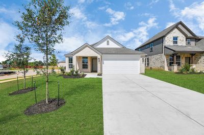 Home features a convenient 2-car garage complemented by a spacious driveway, offering ample parking for you and your guests. | Image 2