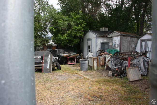 View of yard featuring a shed and an outbuilding | Image 24
