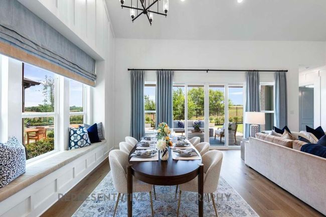 Dining room featuring dark wood-style flooring, a chandelier, and high vaulted ceiling | Image 21