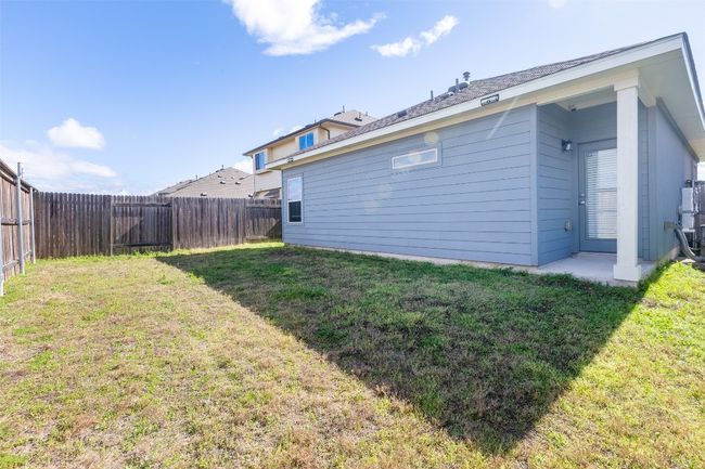 Back of property with a fenced backyard and a yard | Image 33