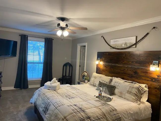 Bedroom with ceiling fan and crown molding | Image 12