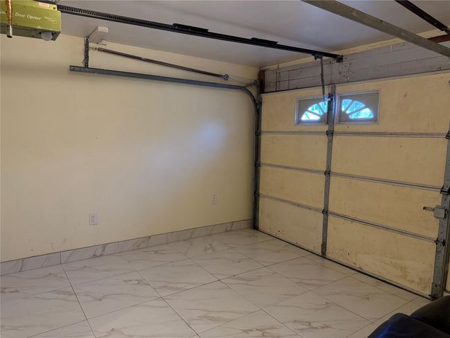 Garage with baseboards and a garage door opener | Image 19