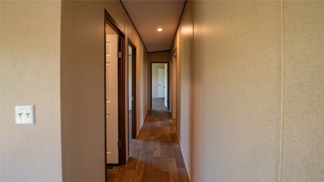 Hallway with wood finished floors and recessed lighting | Image 23