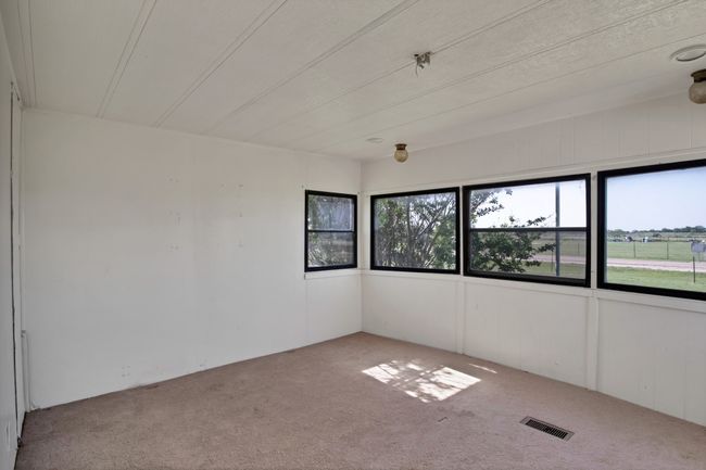View of carpeted spare room | Image 18