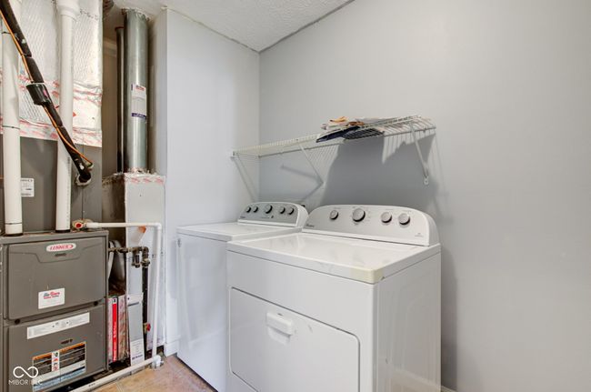 laundry room featuring independent washer and dryer and heating unit | Image 38