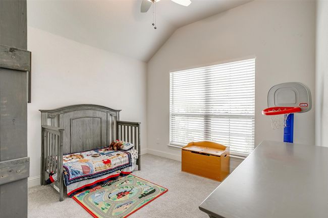 Carpeted bedroom featuring vaulted ceiling, baseboards, and ceiling fan | Image 30