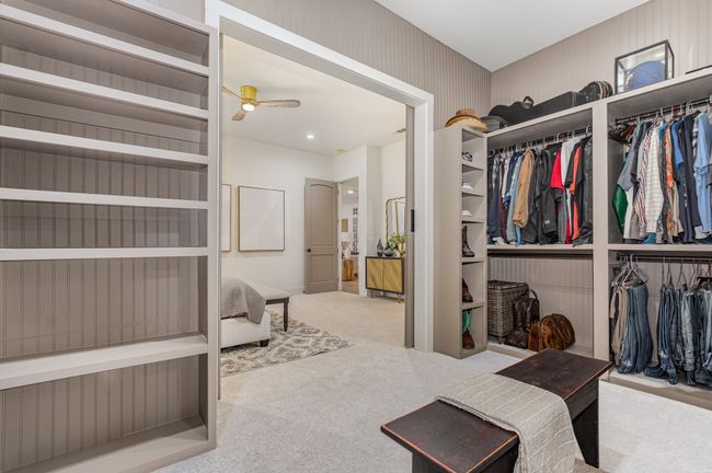 Walk in closet with carpet floors and a ceiling fan | Image 22