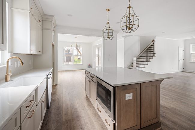 This kitchen features a farmhouse or apron front sink | Image 8