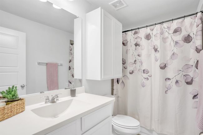 Bathroom featuring vanity, toilet, and a shower with shower curtain | Image 29