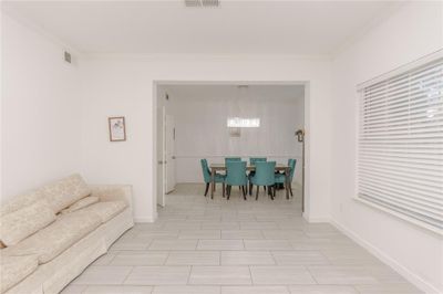 Dining area with ornamental molding and a chandelier | Image 3