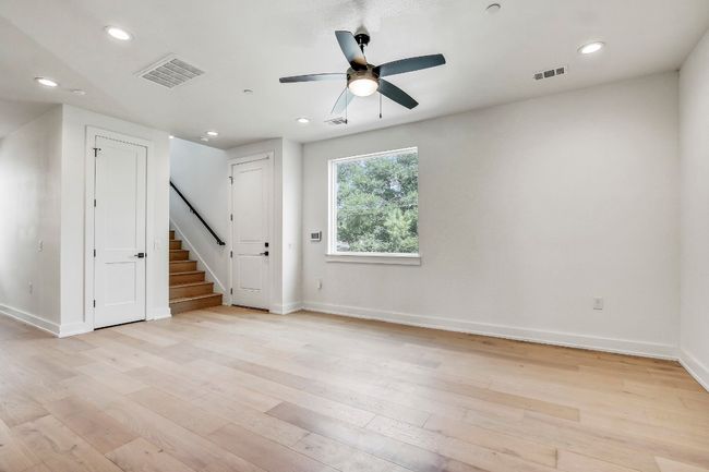 Unfurnished room featuring stairs, a ceiling fan, light wood-type flooring, baseboards, and recessed lighting | Image 9