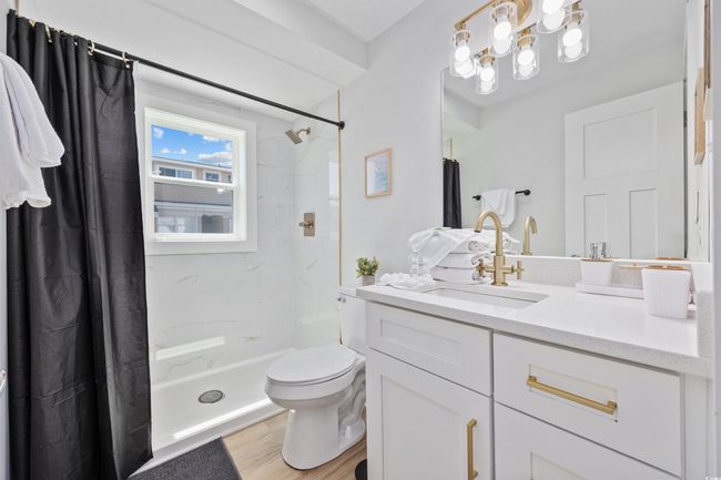 Full bath with toilet, vanity, a shower with curtain, and wood finished floors | Image 20