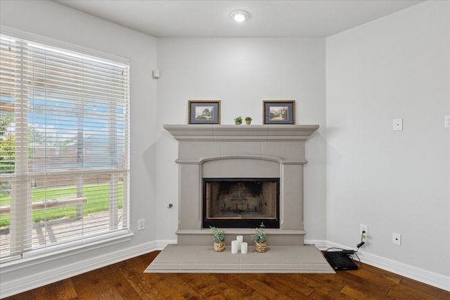 Beautiful corner cast stone fireplace in living area | Image 10