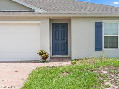 Doorway to property featuring a garage | Image 2