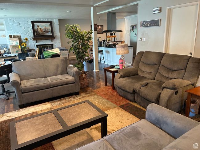 Living room featuring wood finished floors and a fireplace | Image 4