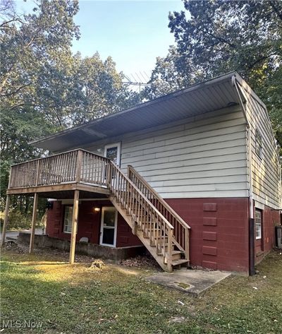 Rear view of house featuring a lawn and a deck | Image 2