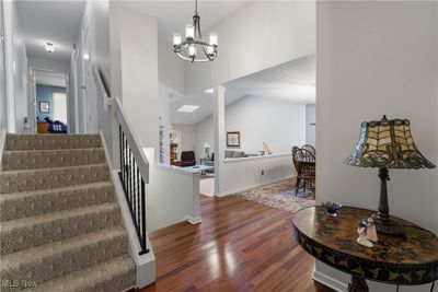 Entryway with dark hardwood / wood-style flooring, a chandelier, and high vaulted ceiling | Image 3