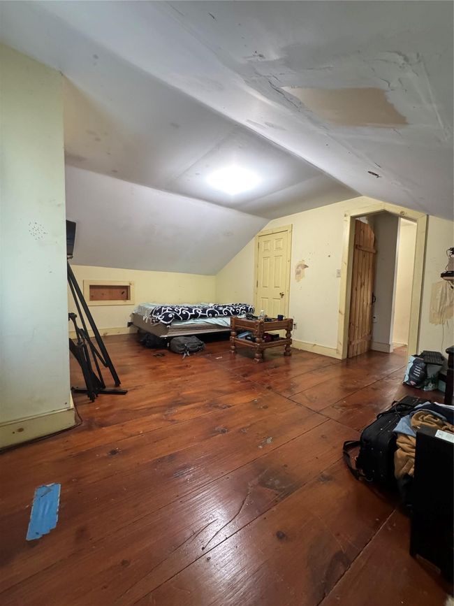 Additional living space with hardwood / wood-style flooring and vaulted ceiling | Image 25