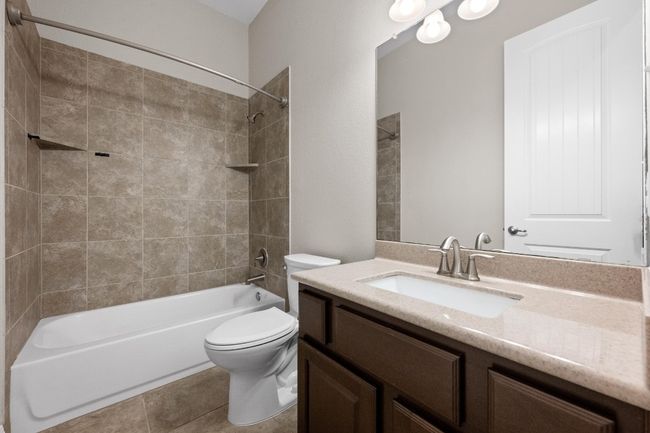Bathroom with vanity, bathtub / shower combination, and tile patterned floors | Image 19