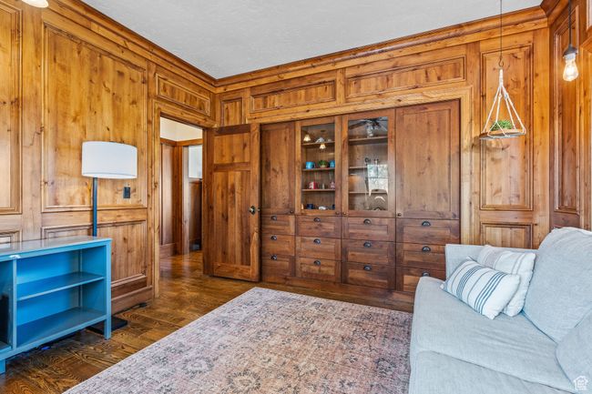 Office with dark hardwood / wood-style floors and wood walls | Image 26