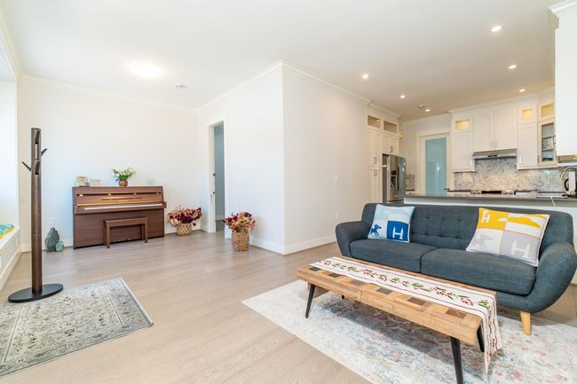Living room featuring light wood-style flooring, crown molding, baseboards, and recessed lighting | Image 10