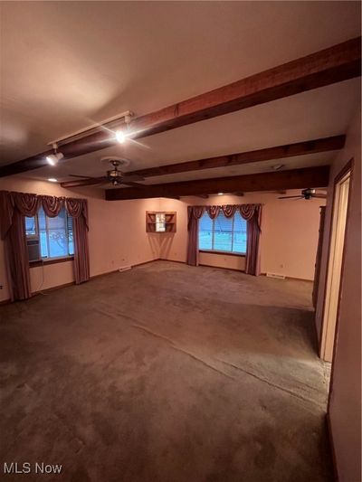 Basement with carpet and ceiling fan | Image 2