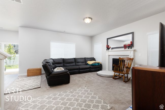 Carpeted living area with a fireplace | Image 7