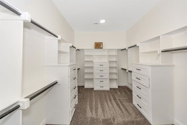 Spacious closet with dark colored carpet and visible vents | Image 27