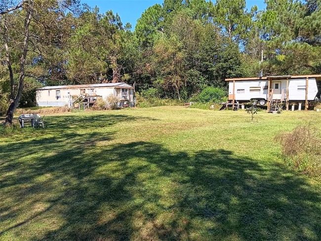 View of yard featuring a forest view | Image 15