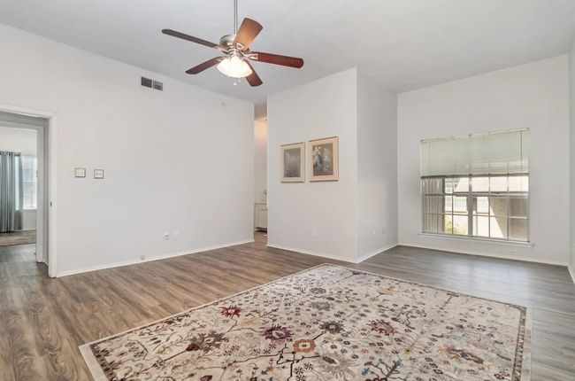 Unfurnished room featuring healthy amount of natural light, a ceiling fan, wood finished floors, and​​‌​​​​‌​​‌‌​‌‌​​​‌‌​​‌‌​‌​​​​​‌ baseboards | Image 4