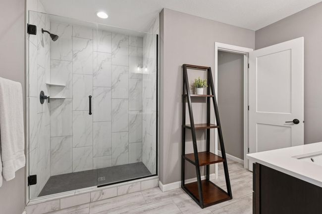 The 3/4 Primary Bathroom was upgraded to include a tiled shower with glass enclosure. | Image 10