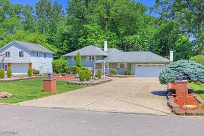 View of Front of Property With Circular Driveway, Pond and 2 Car Attached Garage | Image 3