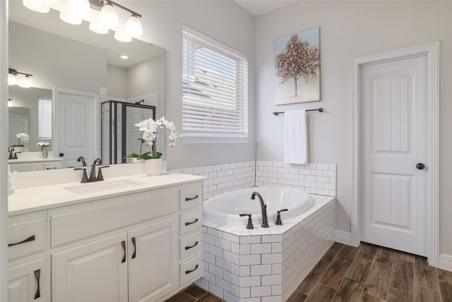 Full bath with a walk-in shower, a garden tub, dual vanity, and wood finished floors | Image 21