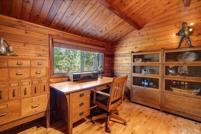 Home office featuring wooden ceiling, light wood finished floors, and wooden walls | Image 16
