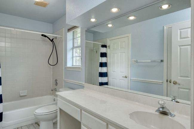 Full bathroom featuring shower / tub combo, toilet, vanity, and recessed lighting | Image 24