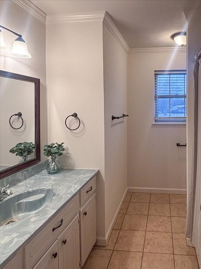 Bathroom with crown molding, tile patterned floors, and vanity | Image 24