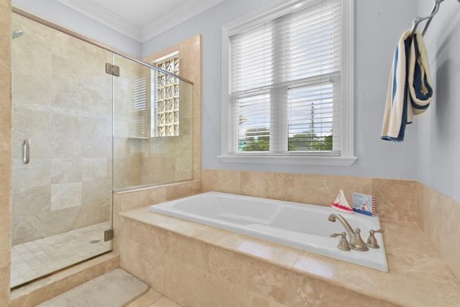 This primary bathroom features a spacious walk-in shower. | Image 26