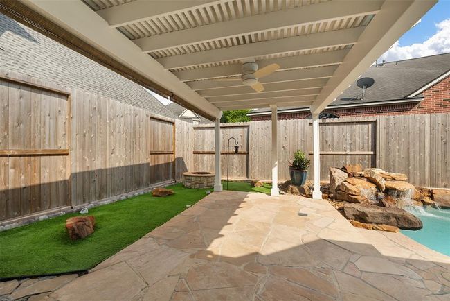 The covered patio is the ultimate extension of the home — perfect for sipping morning coffee, hosting weekend BBQs, or escaping the summer sun. Featuring a 3-inch insulated pergola roof added in 2015, this space offers both comfort and durability, keeping you cool in the heat and protected from the elements. With enough space for both lounging and dining, it’s where memories are made all year long, rain or shine. | Image 46