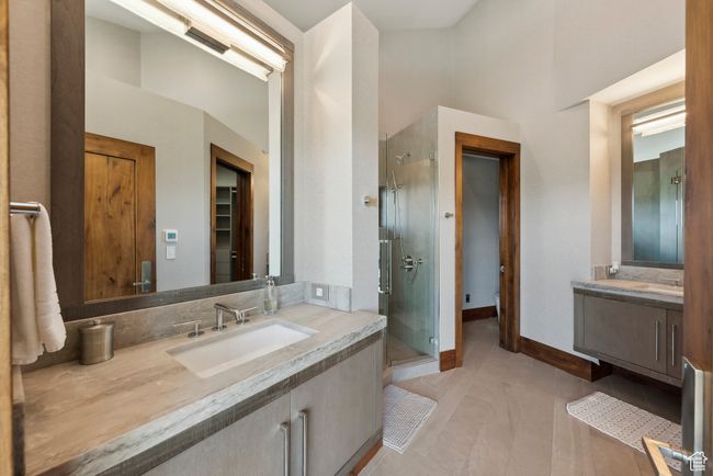 Full bath featuring a stall shower, vanity, tile patterned flooring, and baseboards | Image 44