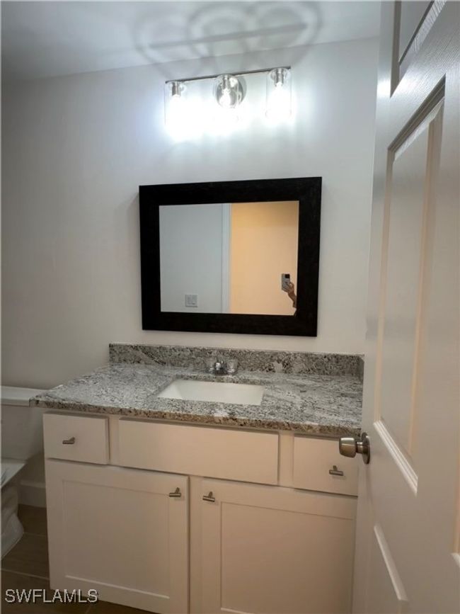 Bathroom featuring toilet and vanity | Image 8