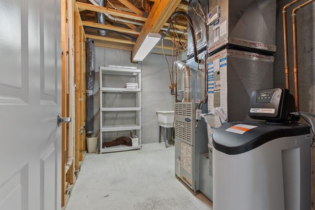 Utility room with convenient utility sink. New hot water heater and water softener installed 2024. | Image 25