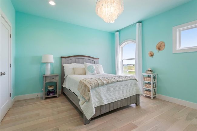 Bedroom featuring multiple windows, a chandelier, wood finished floors, baseboards, and recessed lighting | Image 31