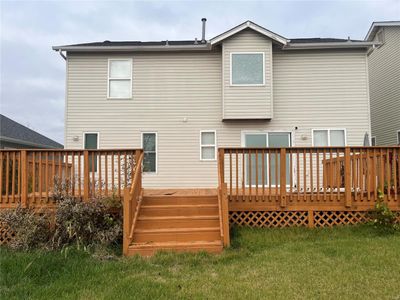 Rear view of property featuring a deck and a lawn | Image 3